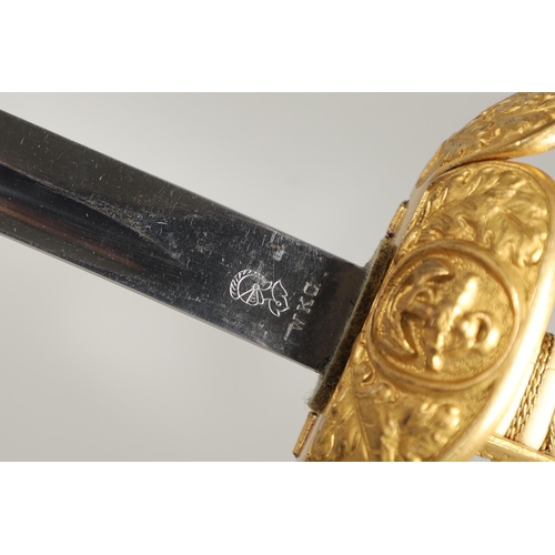 100 - AN IMPERIAL GERMAN NAVAL OFFICER's  SWORD AND SCABBARD. With an 83cm curved, pointed blade with long... 