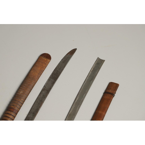 110 - TWO SIMILAR BURMESE DHA TYPE SWORDS AND SCABBARDS. A Burmese sword with a 59cm shaped blade with sha... 