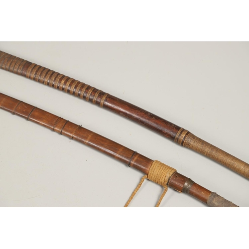 110 - TWO SIMILAR BURMESE DHA TYPE SWORDS AND SCABBARDS. A Burmese sword with a 59cm shaped blade with sha... 