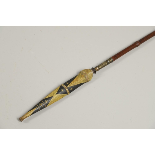 119 - AN INDONESIA SPEAR OR LANCE WITH WAVY EDGED BLADE AND PAINTED SCABBARD. The 31cm wavy edged, taperin... 