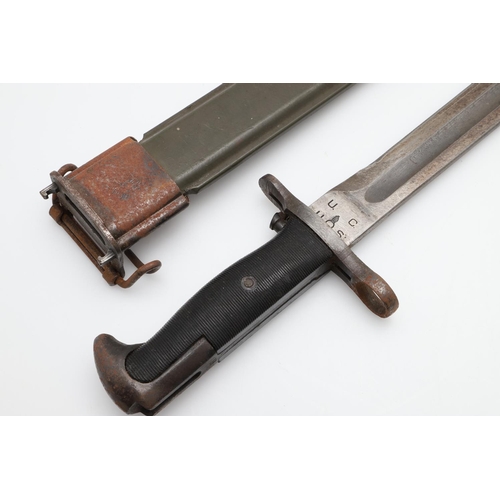 140 - AN AMERICAN 1903 PATTERN BAYONET AND SCABBARD. With a 25cm pointed single edged blade with broad ful... 