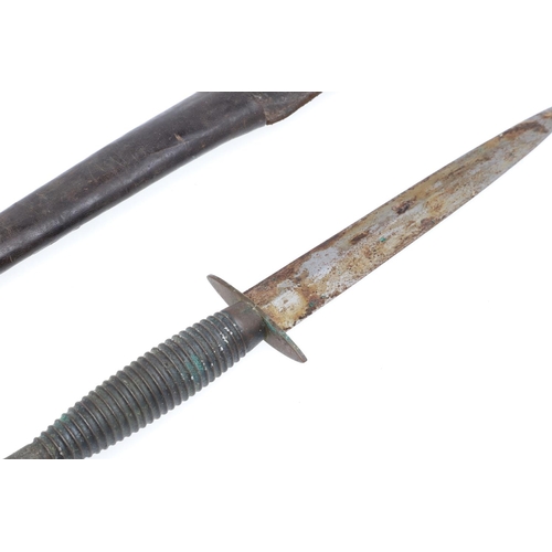 175 - A THIRD PATTERN FAIRBURN SYKES TYPE FIGHTING KNIFE. With a 17cm double edged pointed blade on a flut... 