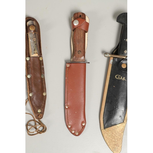 182 - AN AMERICAN CASE HUNTING KNIFE AND THREE OTHERS. A Case hunting knife with a 24cm plated Bowie type ... 