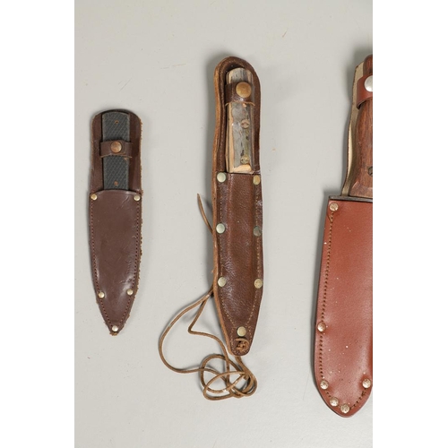 182 - AN AMERICAN CASE HUNTING KNIFE AND THREE OTHERS. A Case hunting knife with a 24cm plated Bowie type ... 