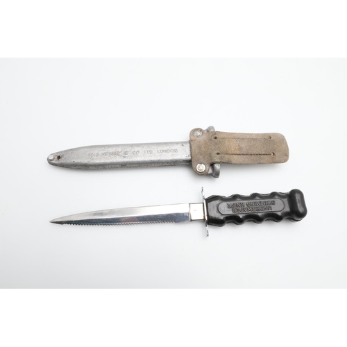 187 - A SIEBE- HEINKE DIVERS KNIFE AND SCABBARD. With a 15cm pointed blade with a single serrated edge, th... 