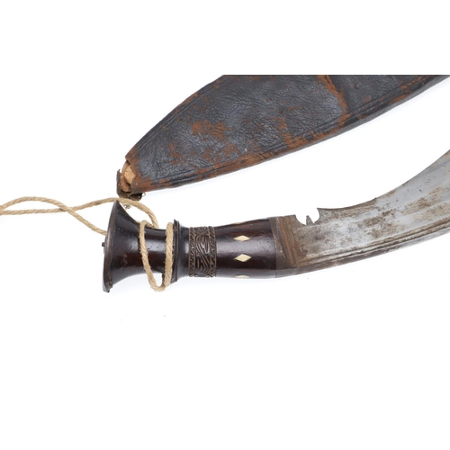 189 - A BROAD BLADED KUKRI KNIFE AND SCABBARD. With a 40cm blade, 7cm broad at the widest point with broad... 