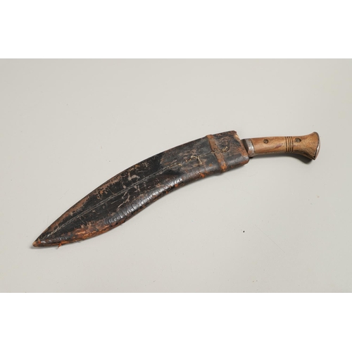 190 - TWO SIMILAR KUKRI KNIVES AND SCABBARDS. A Kukri knife with a shaped 30cm blade with pricked decorati... 