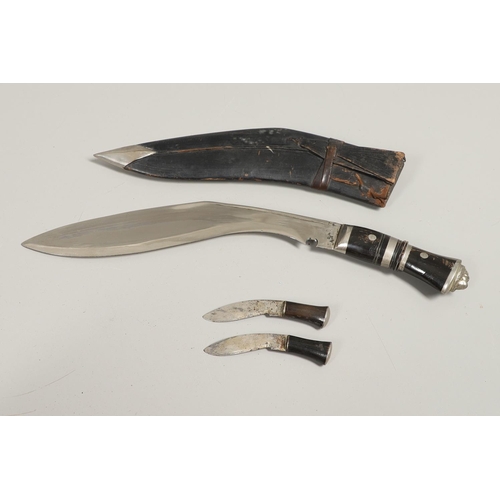 190 - TWO SIMILAR KUKRI KNIVES AND SCABBARDS. A Kukri knife with a shaped 30cm blade with pricked decorati... 