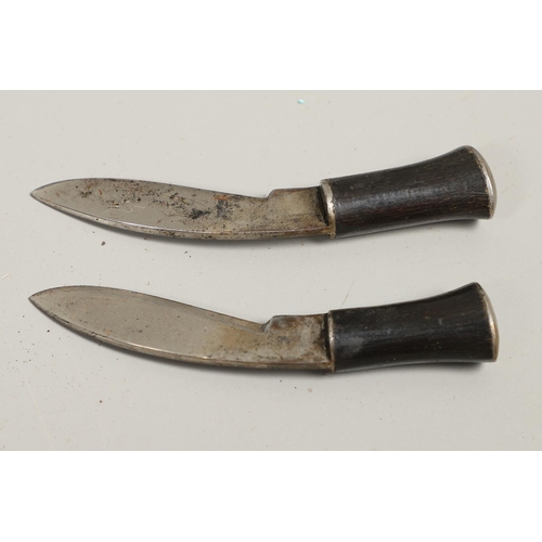 190 - TWO SIMILAR KUKRI KNIVES AND SCABBARDS. A Kukri knife with a shaped 30cm blade with pricked decorati... 