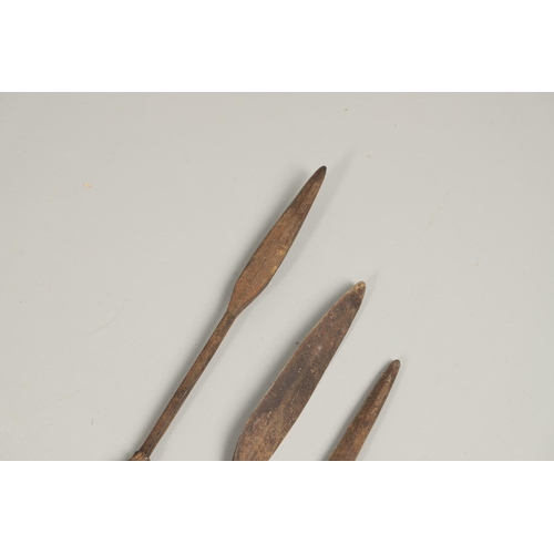 201 - THREE AFRICAN THROWING SPEARS. An African spear with a leaf shaped point on square shaft and wooden ... 