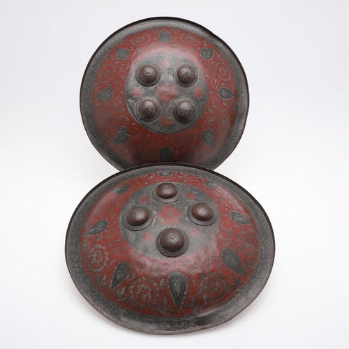 203 - A PAIR OF DECORATED INDIAN CIRCULAR SHIELDS. A pair of 19th century Indian Benares type circular shi... 