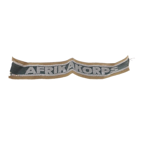 226 - A SECOND WORLD WAR GERMAN AFRIKAKORPS CUFFBAND. An Affrikakorps cuffband, in woven silver wire on a ... 