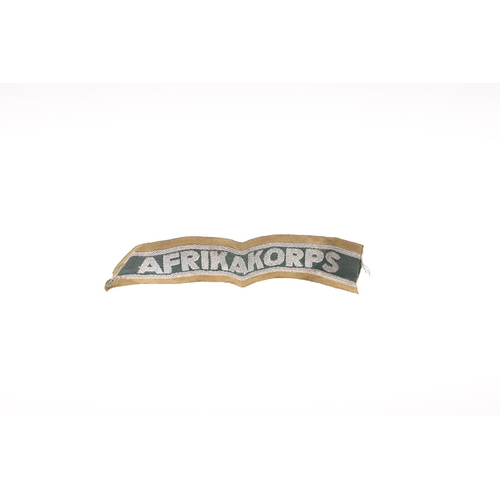 226 - A SECOND WORLD WAR GERMAN AFRIKAKORPS CUFFBAND. An Affrikakorps cuffband, in woven silver wire on a ... 