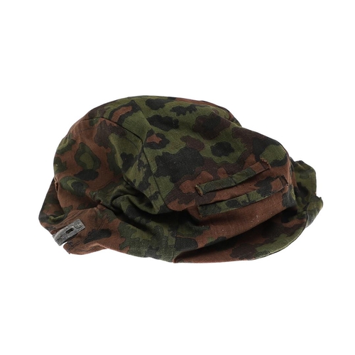 231 - A SECOND WORLD WAR GERMAN WAFFEN-SS STEEL HELMET CAMOUFLAGE COVER. A Waffen-SS steel helmet reversib... 