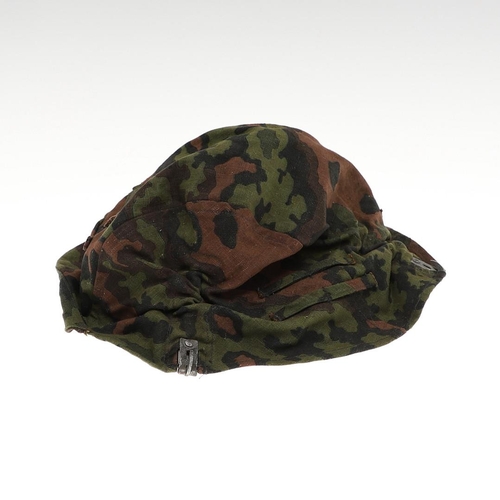 231 - A SECOND WORLD WAR GERMAN WAFFEN-SS STEEL HELMET CAMOUFLAGE COVER. A Waffen-SS steel helmet reversib... 