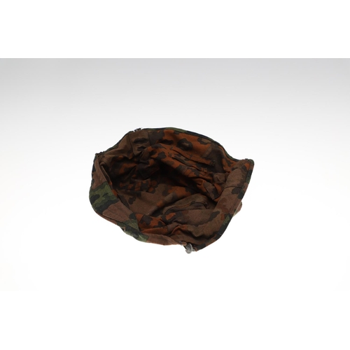 231 - A SECOND WORLD WAR GERMAN WAFFEN-SS STEEL HELMET CAMOUFLAGE COVER. A Waffen-SS steel helmet reversib... 