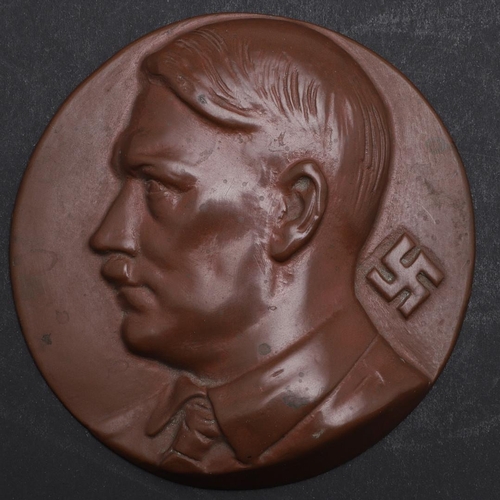 236 - A CAST COMPOSITION PLAQUE OF ADOLF HITLER. A circular cast composition plague, bust of Adolf Hitler ... 