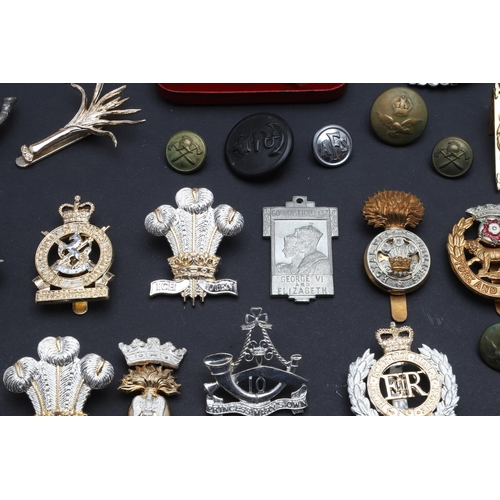 238 - A LARGE COLLECTION OF MILITARY CAP BADGES AND BUTTONS. A collection of modern military cap badges to... 