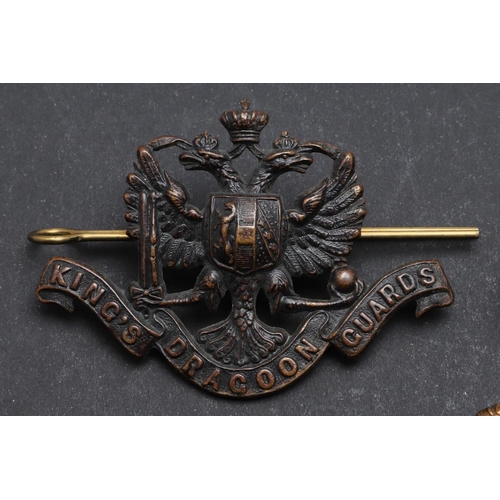 244 - AN INTERESTING COLLECTION OF THREE 1ST KING's  DRAGOON GUARDS CAP BADGES. Three 1st King's  Dragoon ... 