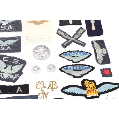 261 - A COLLECTION OF ROYAL FLYING CORPS AND RAF CAP BADGES, PATCHES AND SIMILAR ITEMS. Two Royal Flying C... 