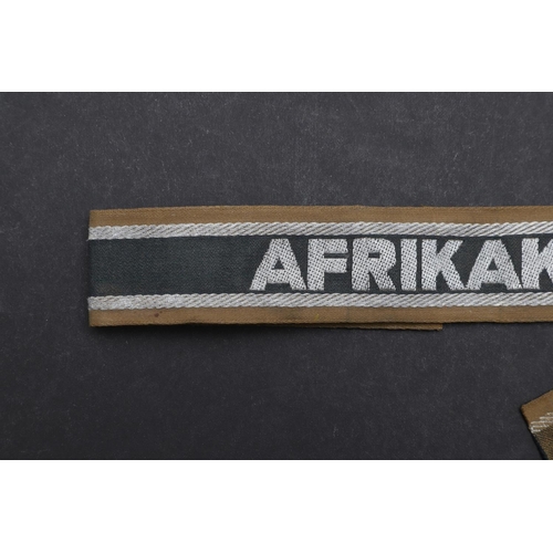 269 - A SECOND WORLD WAR GERMAN 'AFRIKAKORPS' CUFFBAND. A Second World War German machine woven 'Afrikakor... 