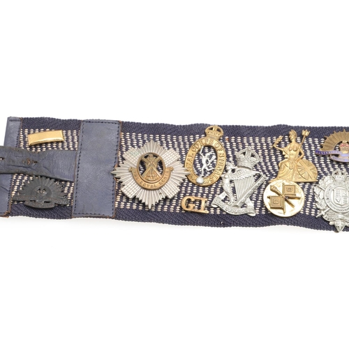 271 - A BELT OF SECOND WORLD WAR CAP BADGES WITH LINKS TO THE SPECIAL OPERATIONS EXECUTIVE. A collection o... 