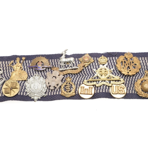 271 - A BELT OF SECOND WORLD WAR CAP BADGES WITH LINKS TO THE SPECIAL OPERATIONS EXECUTIVE. A collection o... 