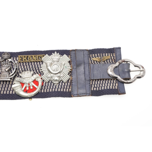 271 - A BELT OF SECOND WORLD WAR CAP BADGES WITH LINKS TO THE SPECIAL OPERATIONS EXECUTIVE. A collection o... 