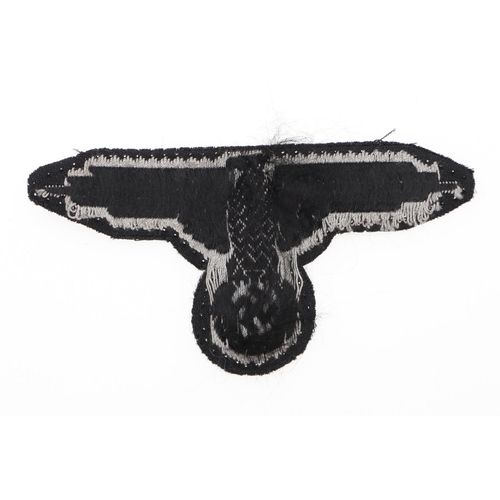 289 - A WAFFEN-SS MAN's  BEVO TYPE ARM-EAGLE. A Man's  Bevo type arm-eagle machine woven in grey silk type... 