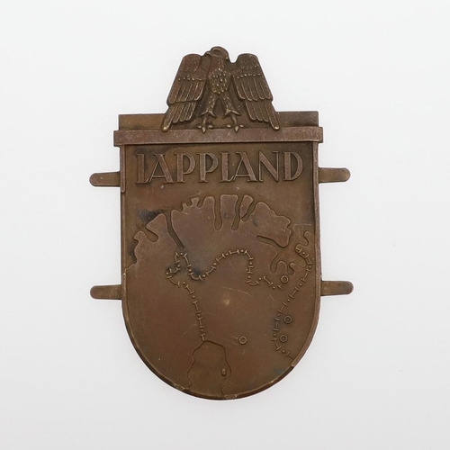 304 - A GERMAN ARMY LAPPLAND CAMPAIGN SHIELD. A Lappland shield, bronze type with rounded base, 6.8cm.  *C... 