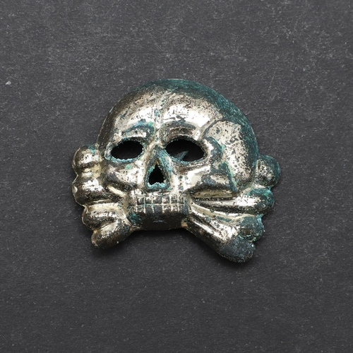 326 - A SECOND WORLD WAR GERMAN SS CAP SKULL BADGE. An Allg.-SS early type cap skull with RZM stamp 'Ges.G... 