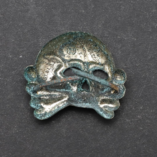 326 - A SECOND WORLD WAR GERMAN SS CAP SKULL BADGE. An Allg.-SS early type cap skull with RZM stamp 'Ges.G... 