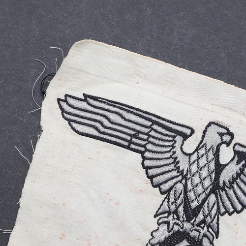 328 - A SECOND WORLD WAR SS FLAG EAGLE. An SS Flag eagle of the type sewn into the corners of SS Command f... 