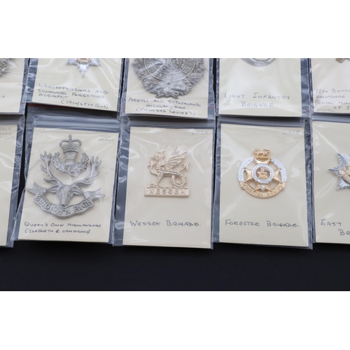 350 - A COLLECTION OF BRITISH ARMY CAP BADGES FOR INFANTRY OF THE LINE POST WORLD WAR ONE. A collection of... 