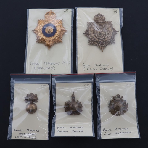 351 - A COLLECTION OF ROYAL MARINES CAP BADGES. A collection of five Royal Marines cap badges to include a... 