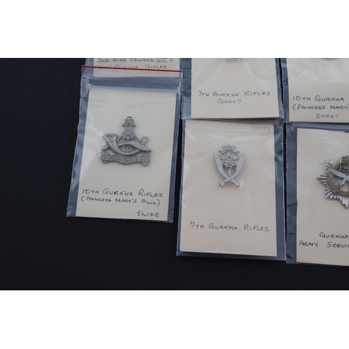 358 - A COLLECTION OF CAP BADGES FOR GURKHA REGIMENTS. A collection of cap and similar badges for the Gurk... 