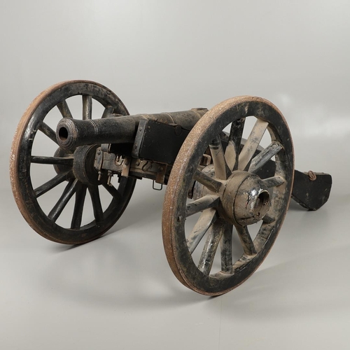 36 - A NAPOLEONIC STYLE CANNON AND CARRIAGE. A cannon with a cast tapering barrel with ringed decoration,... 
