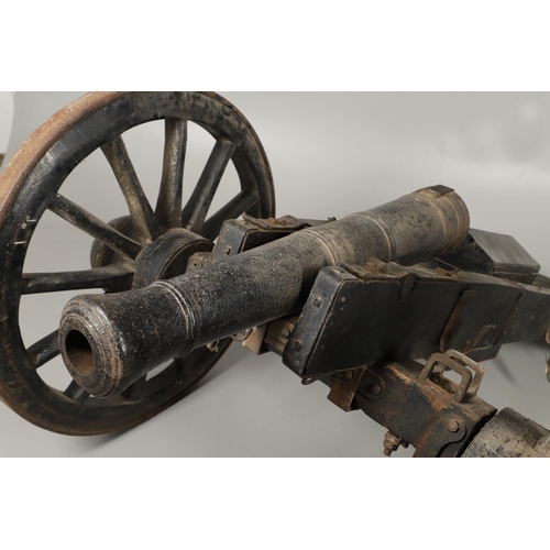 36 - A NAPOLEONIC STYLE CANNON AND CARRIAGE. A cannon with a cast tapering barrel with ringed decoration,... 