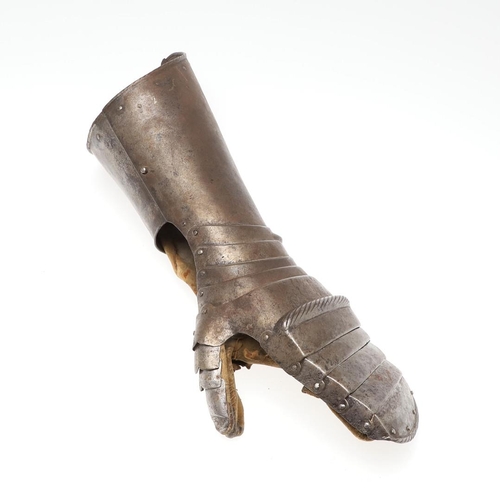 396 - A MID 16TH CENTURY MITTEN GAUNTLET. A steel mitten gauntlet for the left hand, with a flared tubular... 