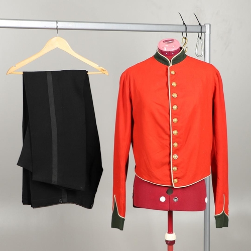 400 - A VICTORIAN 11th REGIMENT OF FOOT (NORTH DEVON) UNIFORM. A red tunic with dark green collar and cuff... 