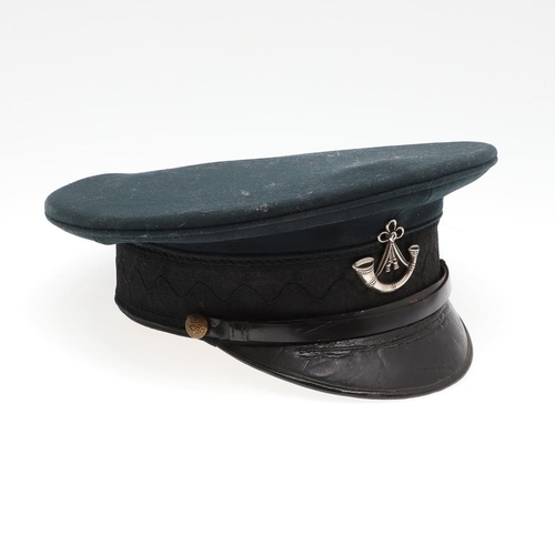 403 - A 1908 PATTERN PEAKED CAP WITH OXFORD AND BUCKS LIGHT INFANTRY BADGE. A black 1908 pattern peaked ca... 