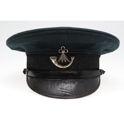 403 - A 1908 PATTERN PEAKED CAP WITH OXFORD AND BUCKS LIGHT INFANTRY BADGE. A black 1908 pattern peaked ca... 