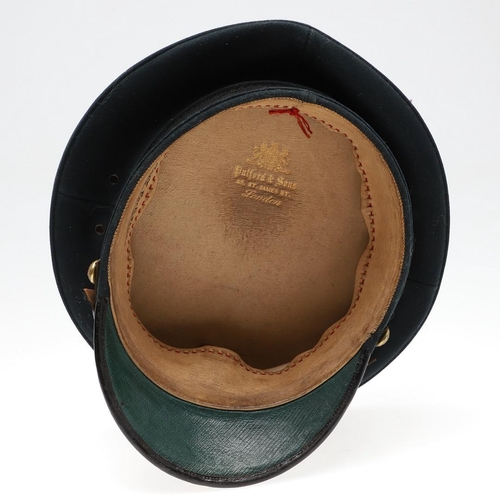 403 - A 1908 PATTERN PEAKED CAP WITH OXFORD AND BUCKS LIGHT INFANTRY BADGE. A black 1908 pattern peaked ca... 