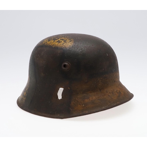 409 - A GERMAN MANUFACTURED TURKISH M1918 STEEL HELMET. The helmet with twin lugs and folded rim, the fron... 