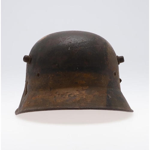 409 - A GERMAN MANUFACTURED TURKISH M1918 STEEL HELMET. The helmet with twin lugs and folded rim, the fron... 