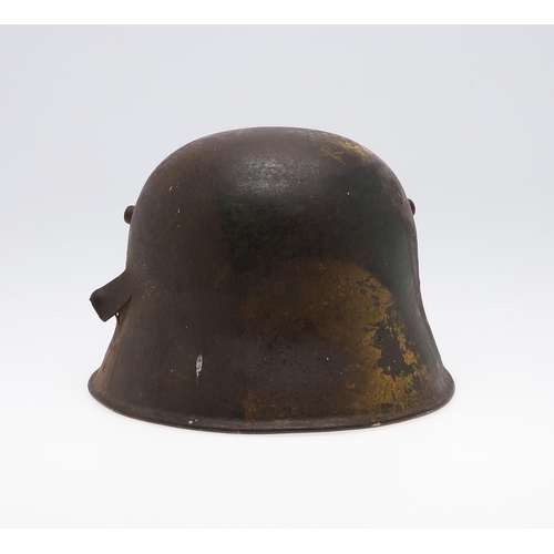 409 - A GERMAN MANUFACTURED TURKISH M1918 STEEL HELMET. The helmet with twin lugs and folded rim, the fron... 