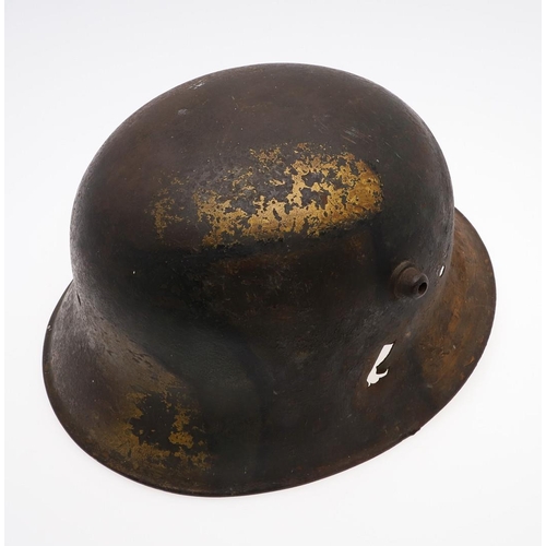 409 - A GERMAN MANUFACTURED TURKISH M1918 STEEL HELMET. The helmet with twin lugs and folded rim, the fron... 