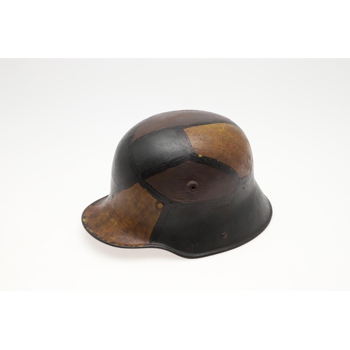 410 - A FIRST WORLD WAR GERMAN M.17 CAMOUFLAGED STEEL HELMET. A Great War steel trench helmet painted with... 