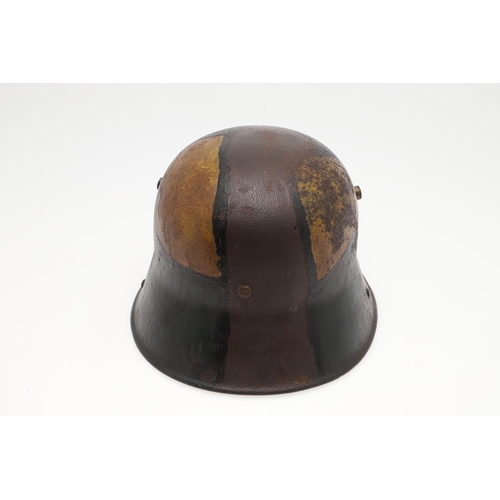 410 - A FIRST WORLD WAR GERMAN M.17 CAMOUFLAGED STEEL HELMET. A Great War steel trench helmet painted with... 