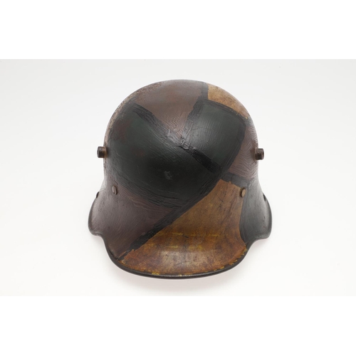 410 - A FIRST WORLD WAR GERMAN M.17 CAMOUFLAGED STEEL HELMET. A Great War steel trench helmet painted with... 